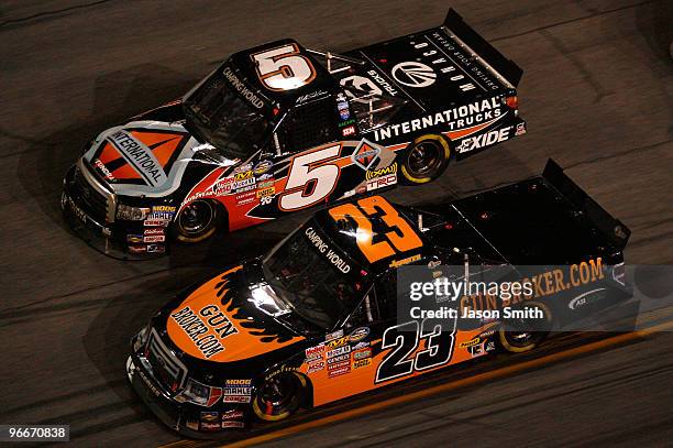 Jason White, driver of the Gunbroker.com Ford, races Mike Skinner, driver of the International Trucks/Monaco RV Toyota, during the NASCAR Camping...