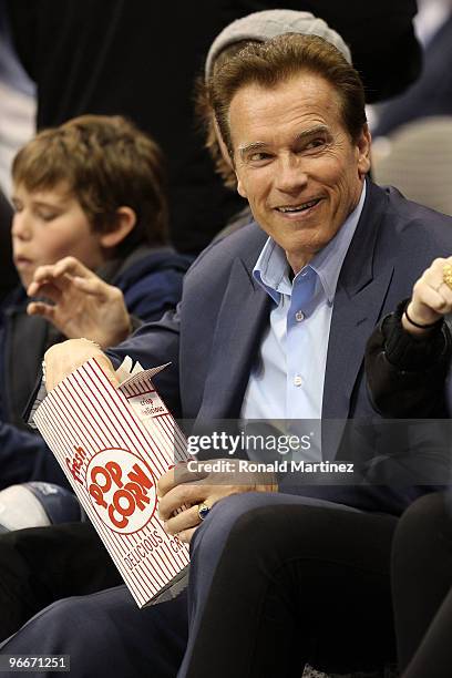 California Governor Arnold Schwarzenegger smiles while watching the Haier Shooting Stars Competition on All-Star Saturday Night, part of 2010 NBA...