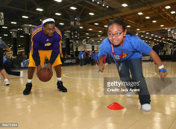 Joe Crawford of the Los Angeles D-Fenders encourages a participant during the Gatorade basketball clinic during Jam Session presented by Adidas...
