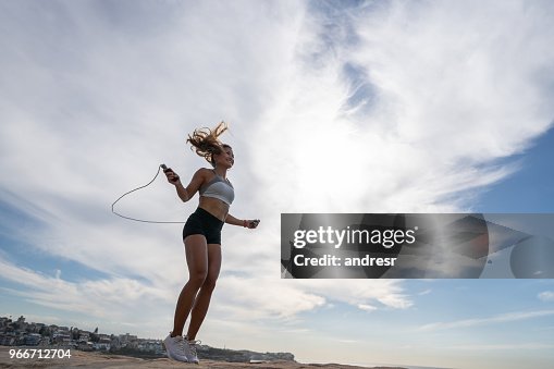 Jump Roping Woman Happy Woman Jumping Rope Outdoors High-Res Stock Photo - Getty Images