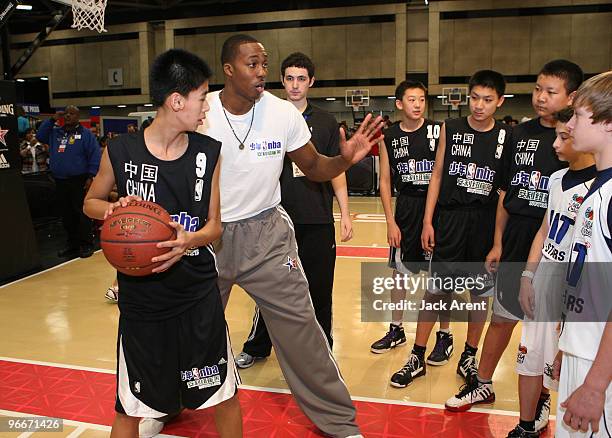 Dwight Howard of the Orlando Magic directs the Jr NBA China Team basketball clinic on the Adidas court during Jam Session presented by Adidas during...