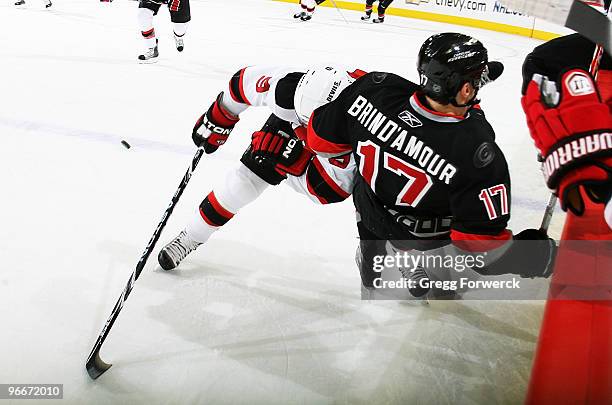 Zach Parise of the New Jersey Devils upends Rod Brind'Amour during a NHL game on February 13, 2010 at RBC Center in Raleigh, North Carolina. The...