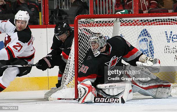 Rob Nidermayer of the New Jersey Devils attempts a wraparound goal on goaltender Justin Peters of the Carolina Hurricanes during a NHL game on...