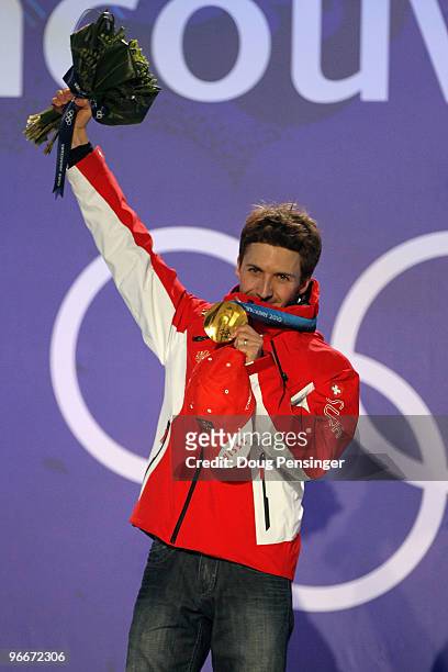 Simon Ammann of Switzerland celebrates with his gold medal during the Medal Ceremony for the Ski Jumping Normal Hill Individual on day 2 of the...