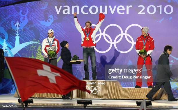 Simon Ammann of Switzerland celebrates with his gold medal and Adam Malysz of Poland and Gregor Schlierenzauer of Austria during the Medal Ceremony...