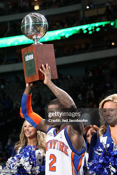 Nate Robinson of the New York Knicks celebrates his third win with the Champions Trophy after the Sprite Slam Dunk Contest on All-Star Saturday...