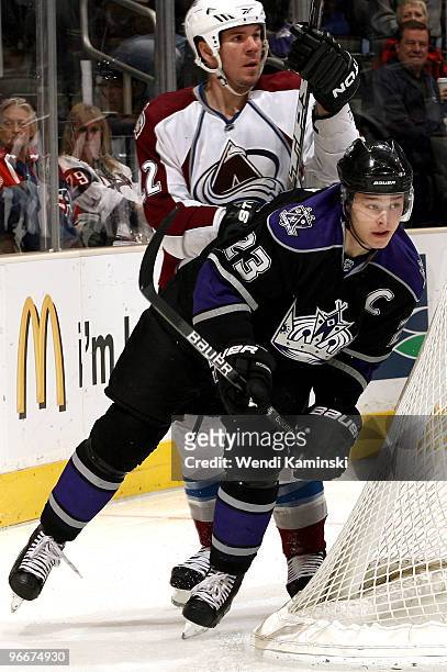 Dustin Brown of the Los Angeles Kings skates ahead of Scott Hannan of the Colorado Avalanche on February 13, 2010 at Staples Center in Los Angeles,...