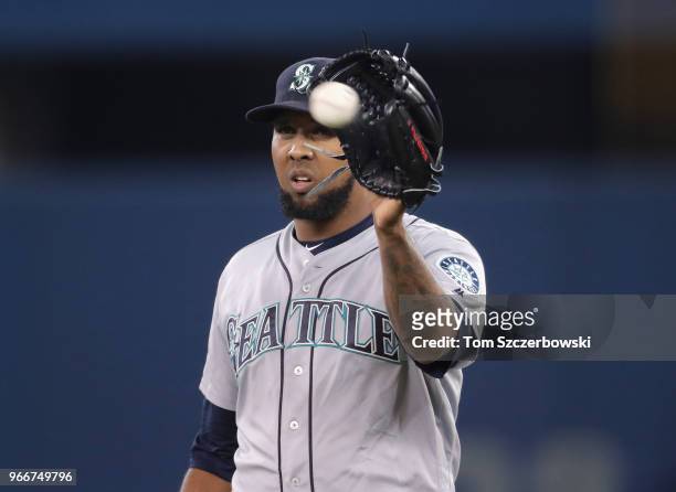 Juan Nicasio of the Seattle Mariners gets the ball as he gets set to pitch in the eighth inning during MLB game action against the Toronto Blue Jays...