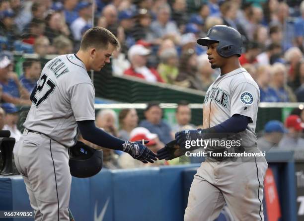 Jean Segura of the Seattle Mariners is congratulated by Ryon Healy after scoring a run in the third inning during MLB game action against the Toronto...