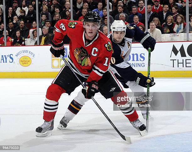 Jonathan Toews of the Chicago Blackhawks and Colby Armstrong of the Atlanta Thrashers wait in position for the puck on February 13, 2010 at the...