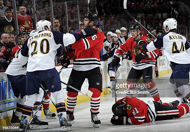 Colby Armstrong of the Atlanta Thrashers and Andrew Ladd of the Chicago Blackhawks push each other as Marian Hossa of the Blackhawks lies on the...