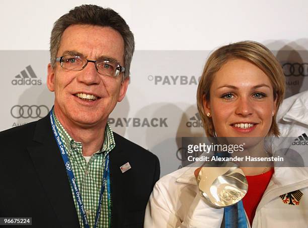 German Interior Minister Thomas de Maiziere talks to Magdalena Neuner of Germany, silver medalist in the Women's Biathlon 7.5 km Sprint on day 2 of...