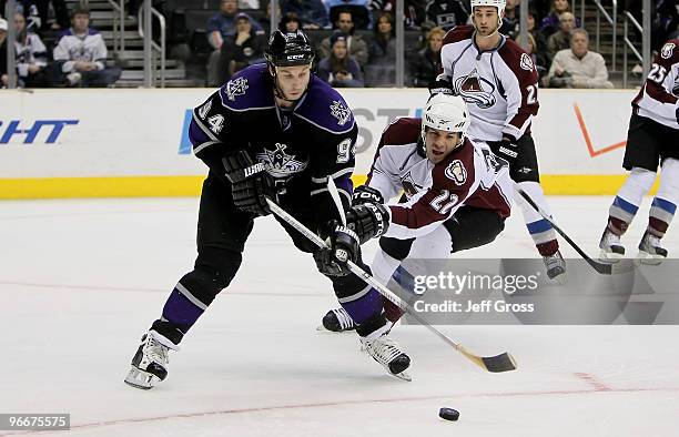 Ryan Smyth of the Los Angeles Kings is pursued by Scott Hannan of the Colorado Avalanche for the puck in the second period at Staples Center on...