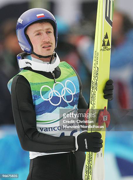 Adam Malysz of Poland looks on during the Ski Jumping Normal Hill Individual event on day 2 of the Olympic Winter Games Vancouver 2010 ski jumping on...