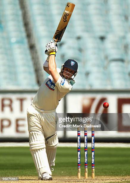 Phillip Hughes of the Blues straight drives during day three of the Sheffield Shield match between the Victorian Bushrangers and the Queensland Bulls...