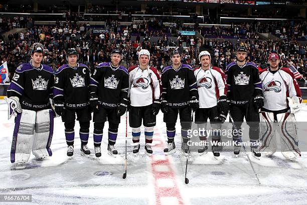 Los Angeles Kings players Jonathan Quick, Dustin Brown, Jack Johnson, Drew Doughty, and Michal Handzus stand with Colorado Avalanche players Paul...