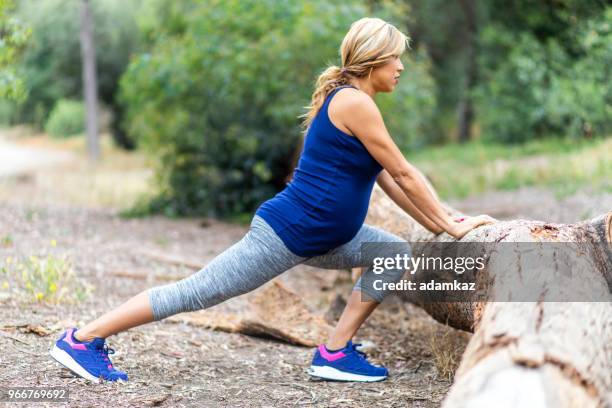 pregnant hispanic woman stretching - hamstring stock pictures, royalty-free photos & images