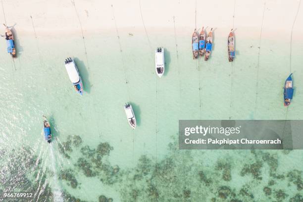 aerial view of thai traditional longtail boats on tropical white sand at sunrise beach, lipe island, thailand. - nocaute - fotografias e filmes do acervo