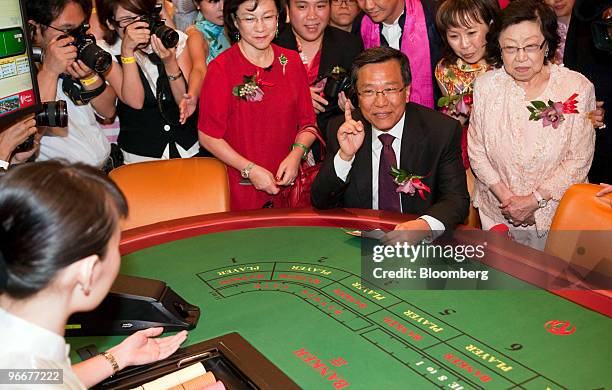 Lim Kok Thay, chairman and chief executive officer of Genting Bhd., places the first bet at the soft opening of Genting Singapore Plc's Resorts World...
