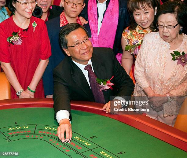 Lim Kok Thay, chairman and chief executive officer of Genting Bhd., places the first bet at the soft opening of Genting Singapore Plc's Resorts World...