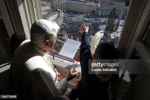 Pope Benedict XVI flanked by Italian Azione Cattolica youngs, sets free a dove from the window of his apartment as a message of peace at the end of...