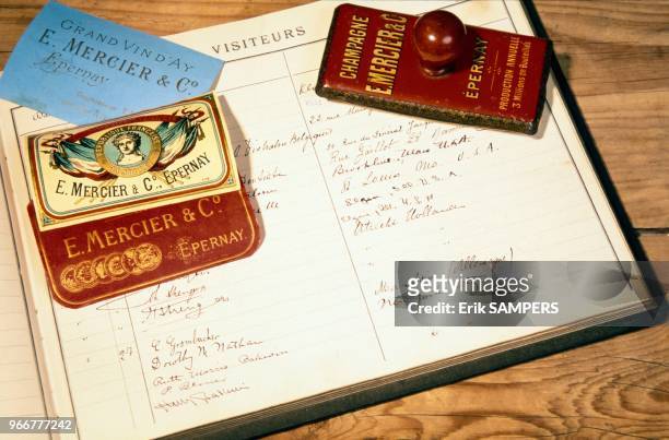 View of the book documenting the number of people who visited the MERCIER caves, the champagne producing company in Epernay. Vue du cahier où était...