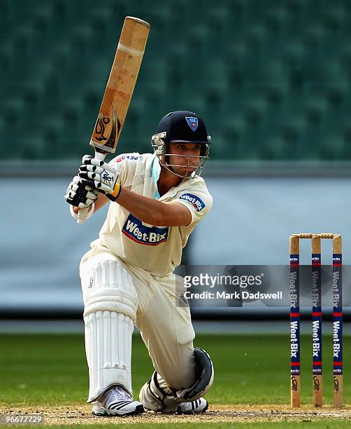 Phillip Hughes of the Blues square drives during day three of the Sheffield Shield match between the Victorian Bushrangers and the Queensland Bulls...