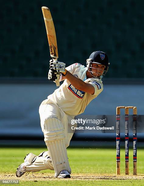 Phillip Hughes of the Blues lofts a shot down the ground during day three of the Sheffield Shield match between the Victorian Bushrangers and the...