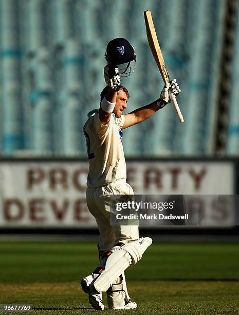 Phillip Hughes of the Blues celebrates his century during day three of the Sheffield Shield match between the Victorian Bushrangers and the...