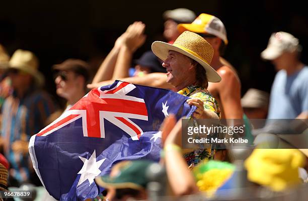 Supporter in the crowd waves and Australia flag during the Fourth One Day International match between Australia and the West Indies at The Gabba on...