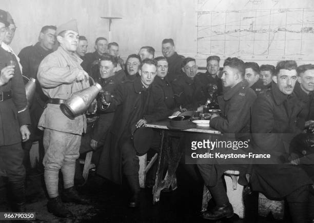 Les soldats français servent le repas aux soldats britanniques dans la cantine de la caserne, à Calais, France le 19 décembre 1934.
