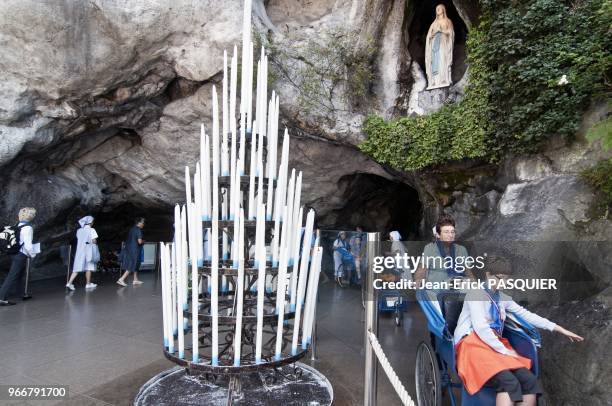 Pilgrims in the grotto of Massabielle where the Virgin Mary appeared to Bernadette Soubirous pictured in Lourdes, France on August 13, 2010.