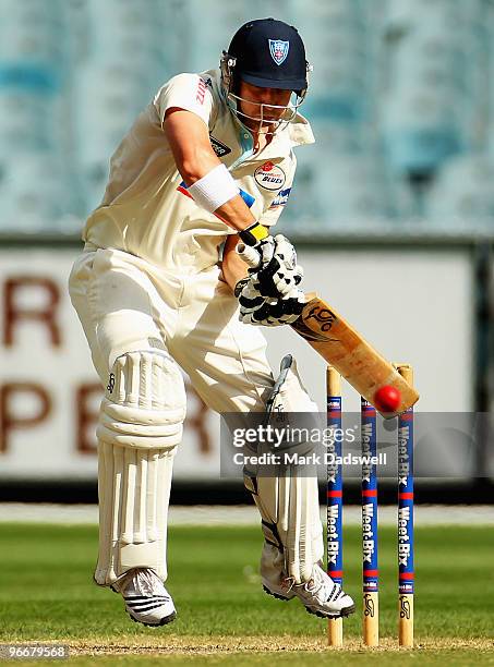 Phillip Hughes of the Blues plays defensively during day three of the Sheffield Shield match between the Victorian Bushrangers and the Queensland...