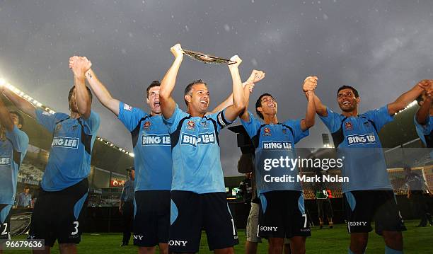 Steve Corica of Sydney holds the Minor Premiership trophy as Sydney salute the crowd after the round 27 A-League match between Sydney FC and the...