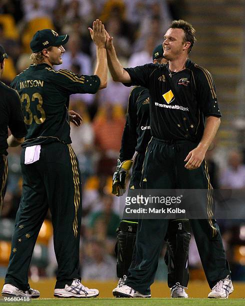 Shane Watson congratulates Doug Bollinger of Australia after taking the wicket of Denesh Ramdin of the West Indies during the Fourth One Day...