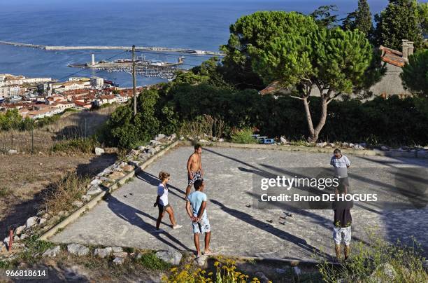 People playing lawn bowling on the top of Mont Saint Clair hill on August 15, 2010 in Sete, France.