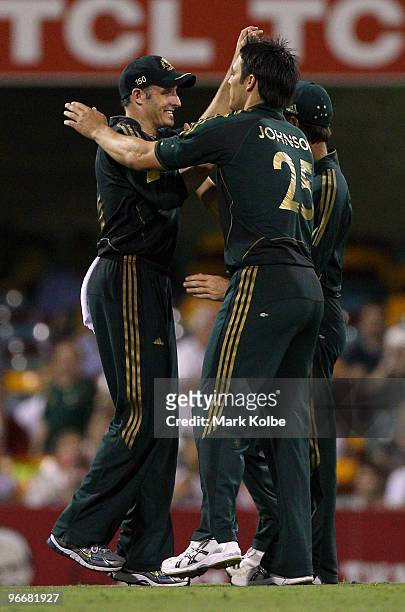 Michael Hussey and Mitchell Johnson of Australia celebrate after the wicket of Kieron Pollard of the West Indies during the Fourth One Day...