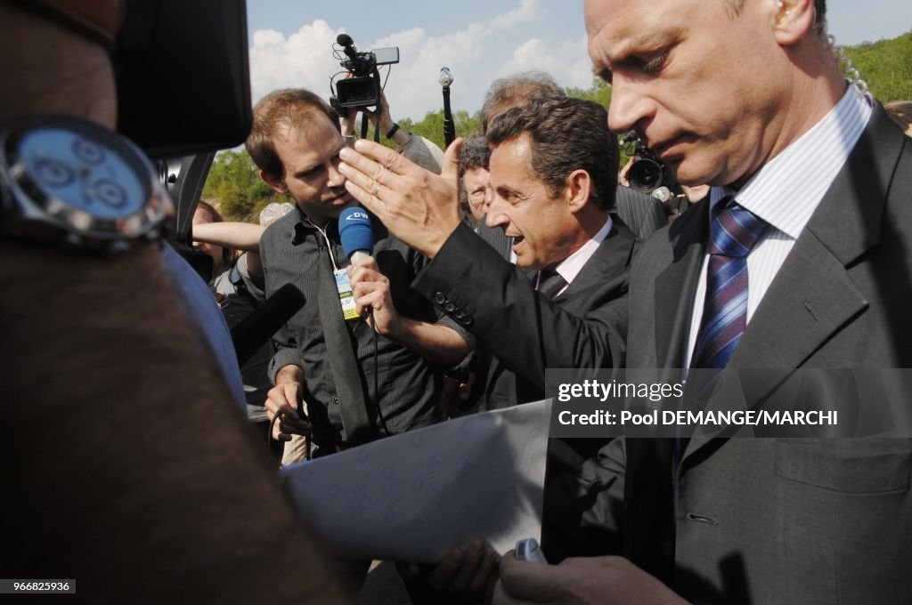 French right-wing presidential candidate of the ruling party Union for a Popular Movement (UMP) Nicolas Sarkozy (R) speaks with former coal miners as he visits a former shaft in Petite-Rosselle, eastern France.