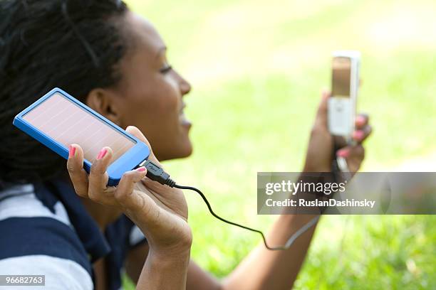 use green energy - solar charger - mobile phone charger stock pictures, royalty-free photos & images