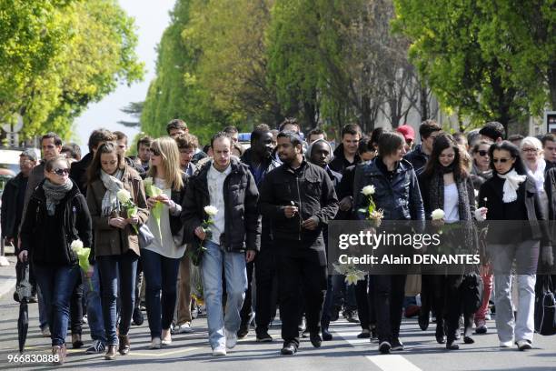 People take part in a silent march to mark the first anniversary of the murders of the five Dupont De Ligonnes family members killed in their home in...