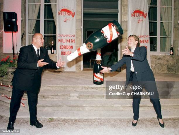 Paul Bocuse fakes a rugby pass by throwing a Mumm champagne bottle to Anne Alaphilippe, captain of France women¿s rugby team, winner of the European...