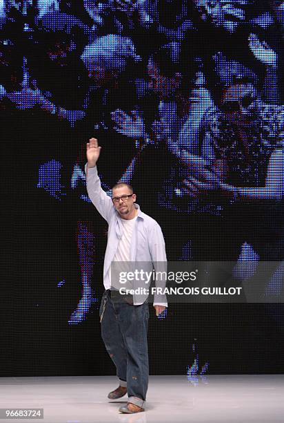 British designer Alexander McQueen waves at the end of his ready-to-wear Spring-Summer 2010 fashion show on October 6, 2009 in Paris. AFP PHOTO...