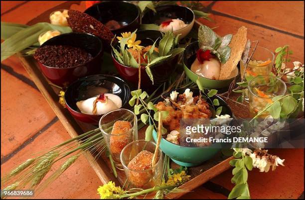 Beignets of acacia flowers, frozen foam of banana with coconut milk and tuiles with rosemarin and rose petals, orange-lemon-chocolate bugnes with...