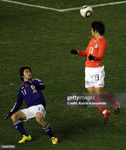 Keiji Tamada of Japan and Joo Ho Park of South Korea are in action during the East Asian Football Championship 2010 match between Japan and South...