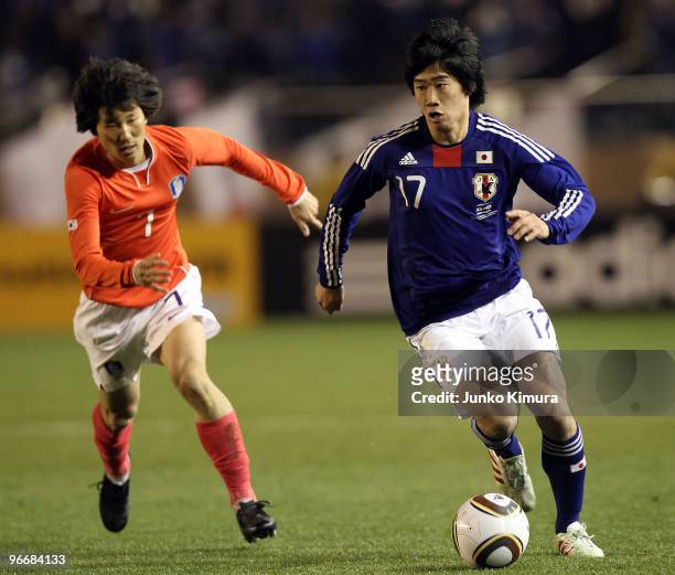 Shinji Kagawa of Japan and Jae Sung Kim of South Korea compete for the ball during the East Asian Football Championship 2010 match between Japan and...