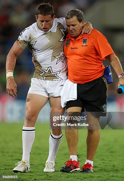 Kurt Gidley of the NRL All Stars is helped from the field with an injury knee during the Indigenous All Stars and the NRL All Stars match at Skilled...