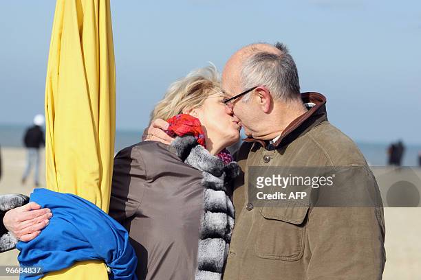 Couple re-enacts the kiss scene of French film director Claude Lelouch's 1966 movie, "Une Homme et Une Femme" film filmed on Deauville's beach...