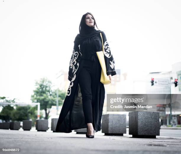 young beautiful woman walking on the street - hijab fashion stockfoto's en -beelden