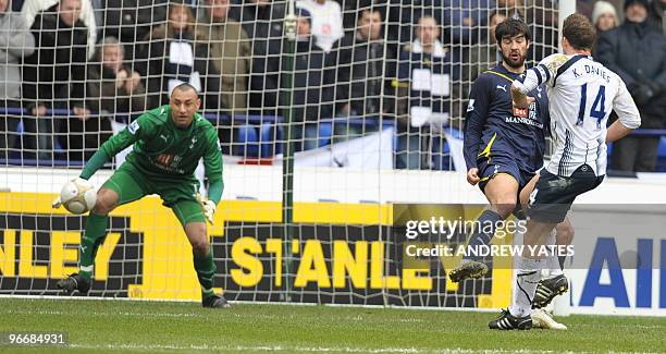 Bolton Wanderers' English forward Kevin Davies scores the opening goal past Tottenham Hotspur's Brazilian goalkeeper Heurelho Gomes during the FA Cup...