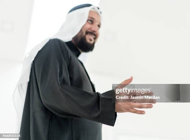 middle eastern guy smiling - business hand shake with arabs stock pictures, royalty-free photos & images